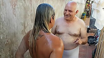 Old Man Helps Young Latina Clean Up After Beach Fun